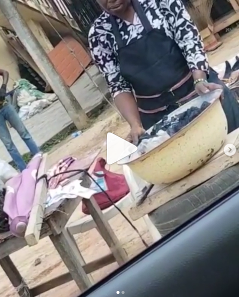 Pastor gifts corn seller money after spotting her praying over her charcoal pot (video)